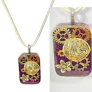 Steampunk purple and gold resin pendant.